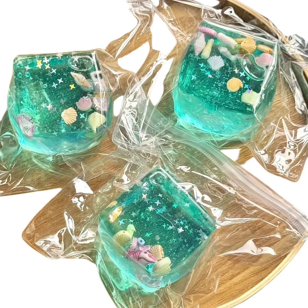 Teal square resin fidget toy cube with embedded seashells and star glitter for stress relief and sensory play