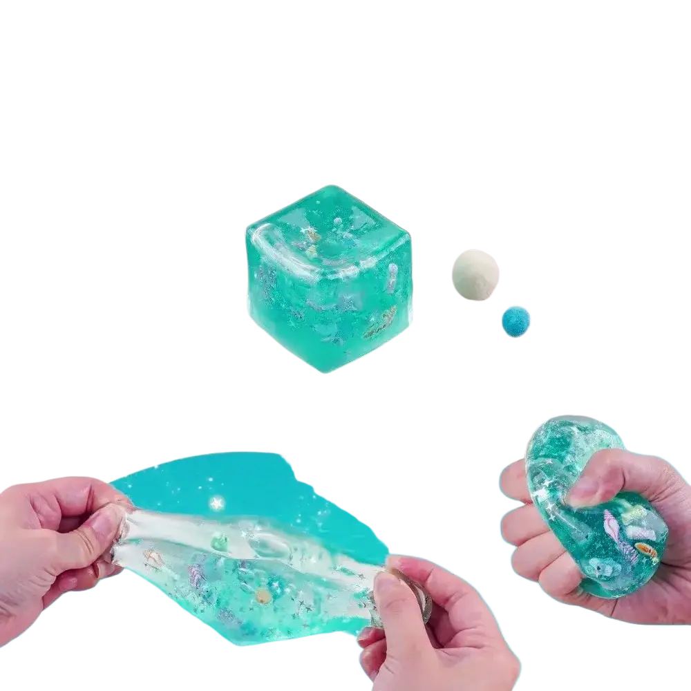 Teal translucent cube fidget toy with embedded glitter and small sea creature figurines for stress relief