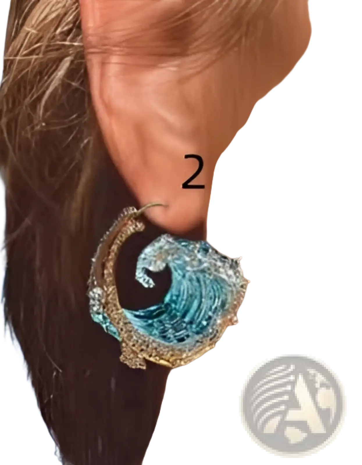 Blue and gold wave-shaped hoop earrings with intricate detailing complement ocean wave turquoise glass pendant necklace with gold accents