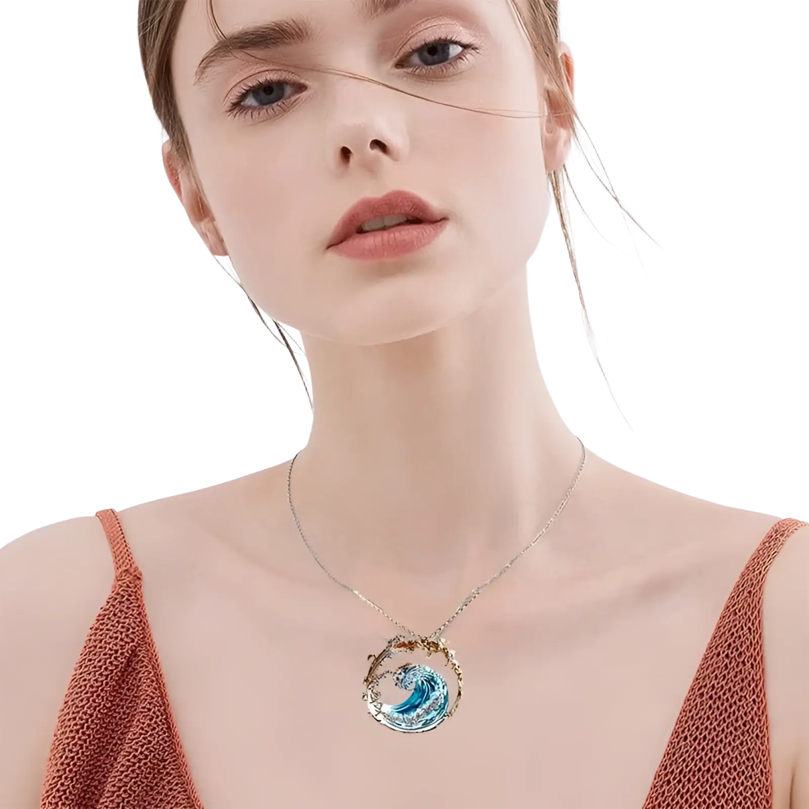 A delicate silver necklace with a circular turquoise glass pendant featuring an intricate blue wave design and gold accents