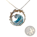 A delicate ocean wave turquoise glass pendant necklace with gold accents and clear gemstones on a gold-toned chain