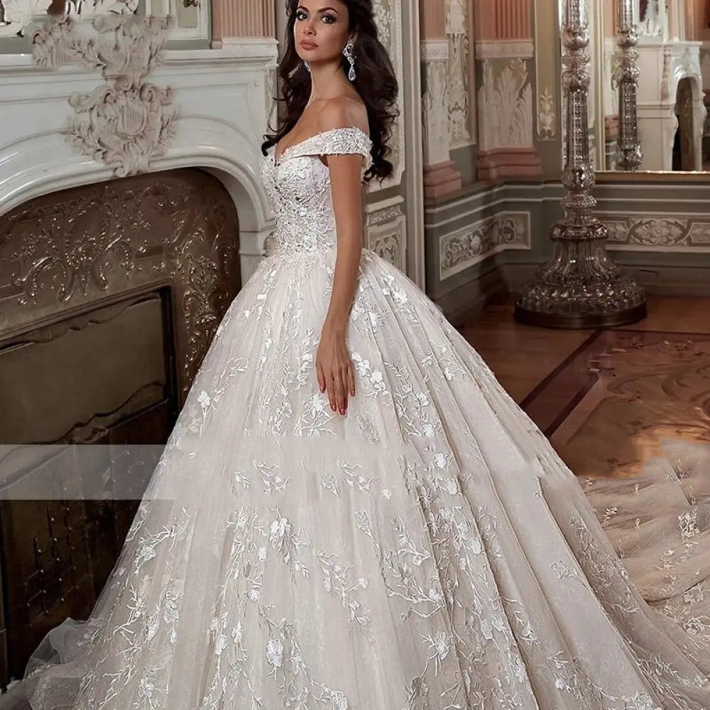 A stunning ivory French Mori embroidered off-shoulder tulle wedding dress with silver floral embroidery and lace detailing