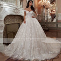 A stunning ivory French Mori embroidered off-shoulder tulle wedding dress with intricate floral lace and voluminous skirt