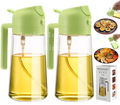 Two lime green and clear glass 500ml oil sprayers with handles filled with golden yellow kitchen oil for oil spray