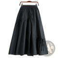 Black high-waisted a-line skirt with elastic waistband and side tie details for a stylish casual look