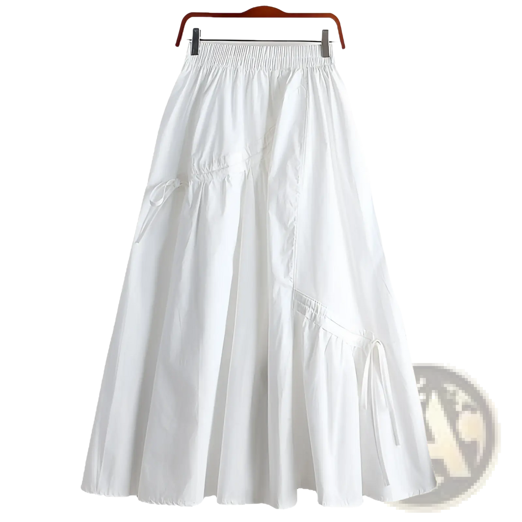 White flowing maxi skirt with elastic waistband and side drawstrings shown with olive green a-line skirt ties