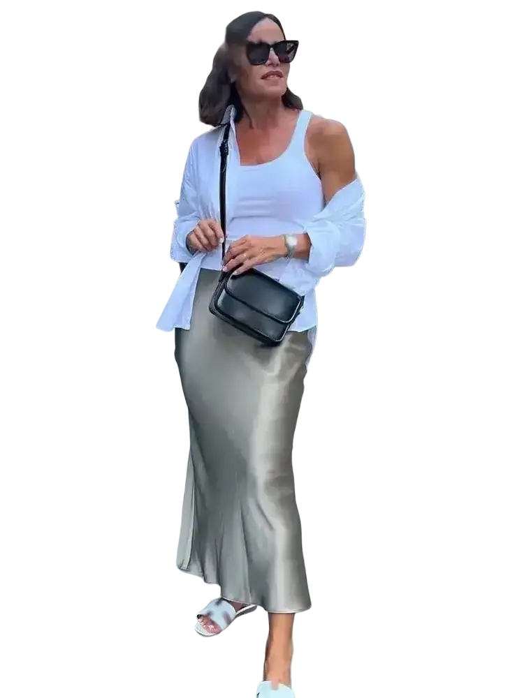 Black leather crossbody bag with sleek rectangular design complements olive green satin maxi skirt