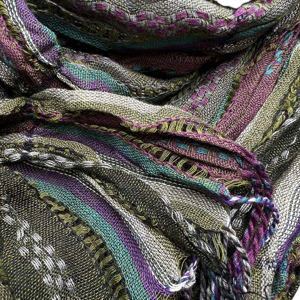 A woven olive jacquard crinkle scarf with textured multicolored stripes of green purple teal and white