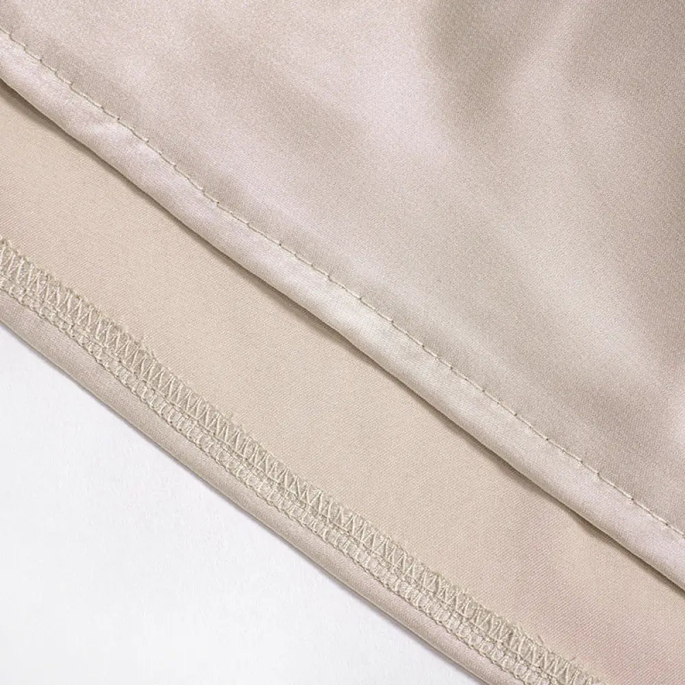 Beige satin ruched one shoulder backless mini dress fabric showing fine matching thread stitching along hem