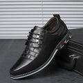 Men’s British two-tone leather dress shoe in black with silver eyelets and a textured toe pattern