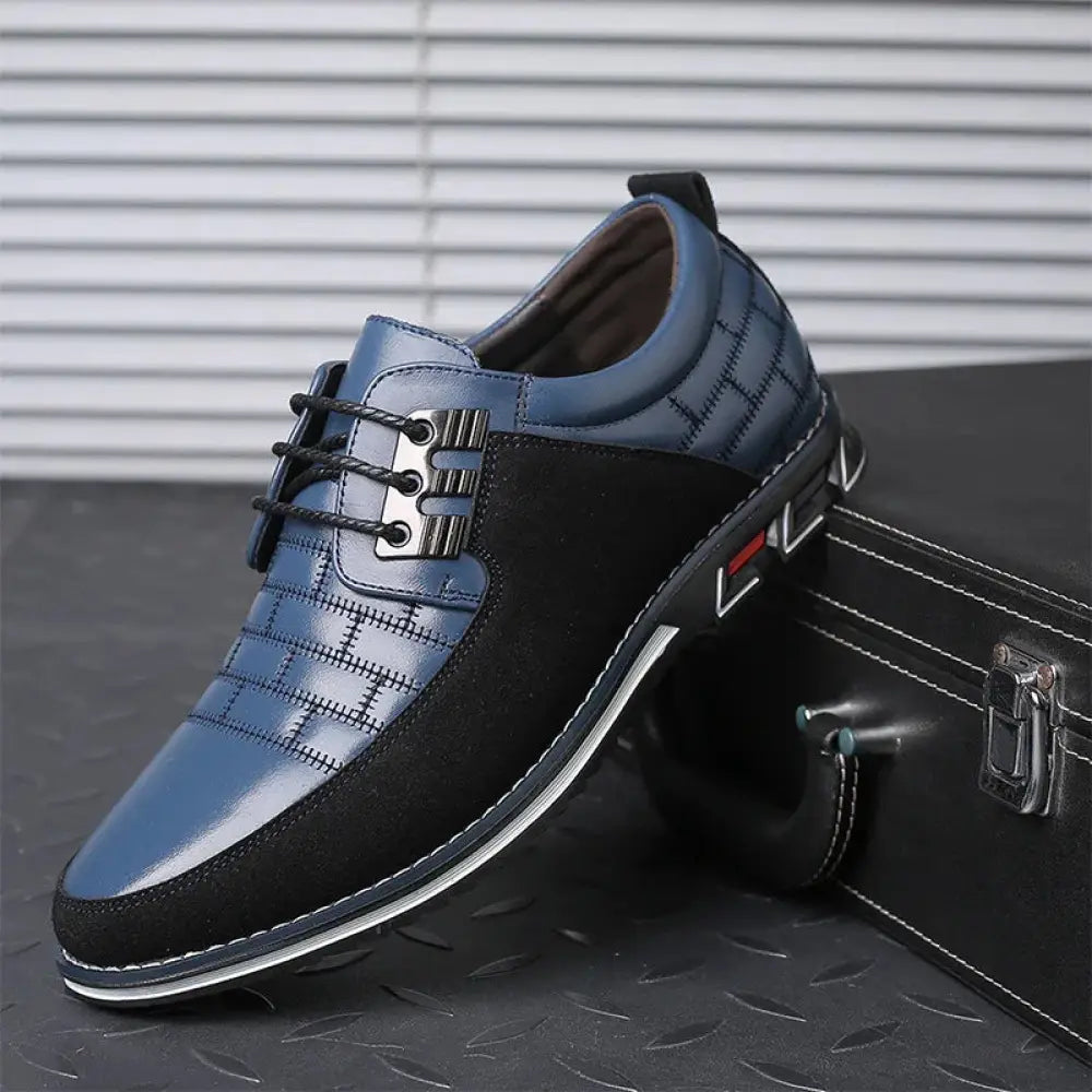 Men’s British two-tone leather dress shoe in blue and black with textured pattern on lace-up toe cap