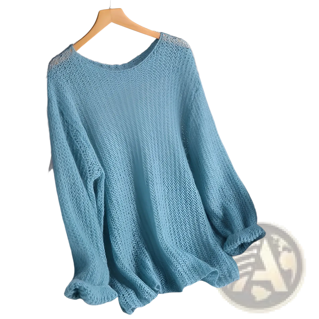 A soft light blue open-knit pullover blouse style knit top with loose fit and ribbed cuffs hanging on wooden hanger
