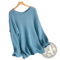 A soft light blue open-knit pullover blouse style knit top with loose fit and ribbed cuffs hanging on wooden hanger