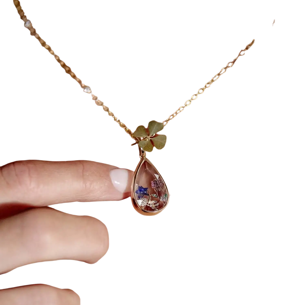 A delicate gold open pendant necklace for women girls simple fashion featuring a teardrop pendant with dried flowers