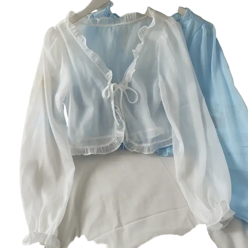 A delicate white sheer cropped cardigan blouse with open stitch design ruffled edges and front tie closure