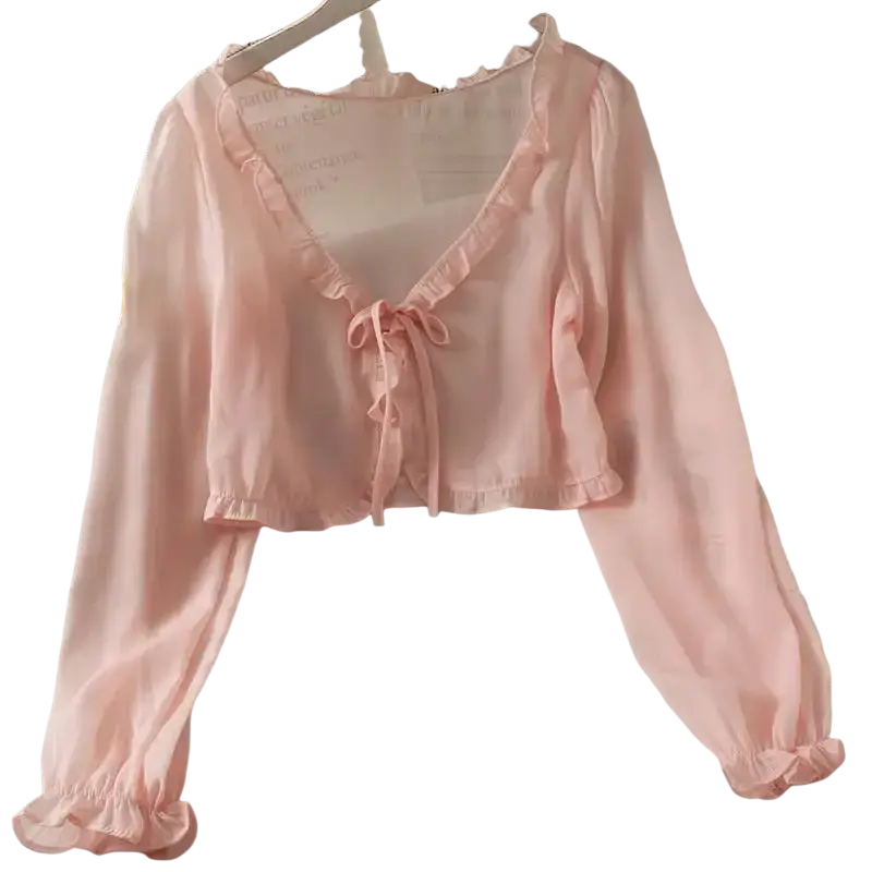Delicate pink sheer long-sleeved crop top with ruffled edges and front tie detail in an open stitch design