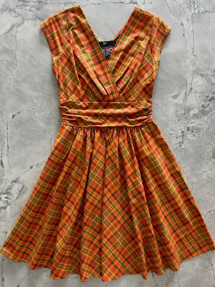 A vibrant orange and yellow plaid cotton dress with v-neckline, cinched waistband, short sleeves, and pockets