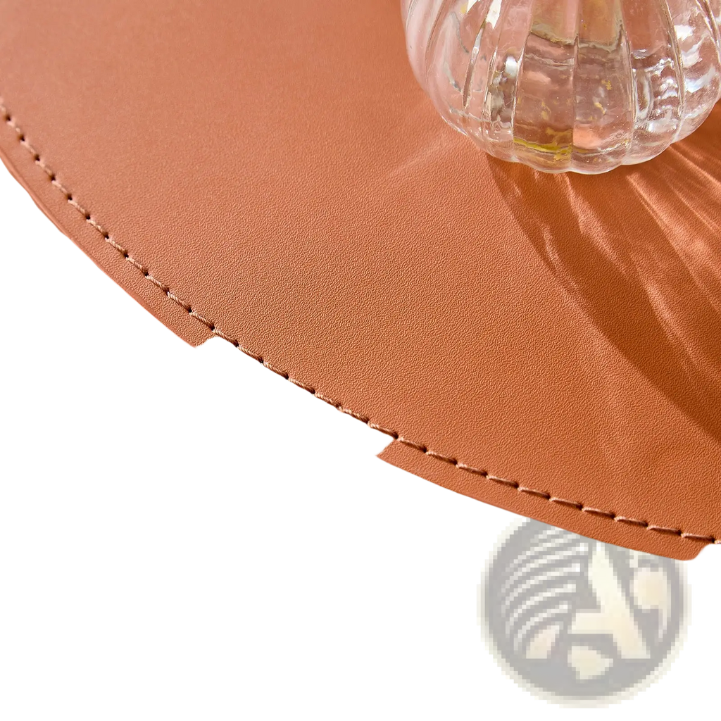 Tan leather bucket with curved top and precise stitching along rim from orange saddle leather round coffee table set