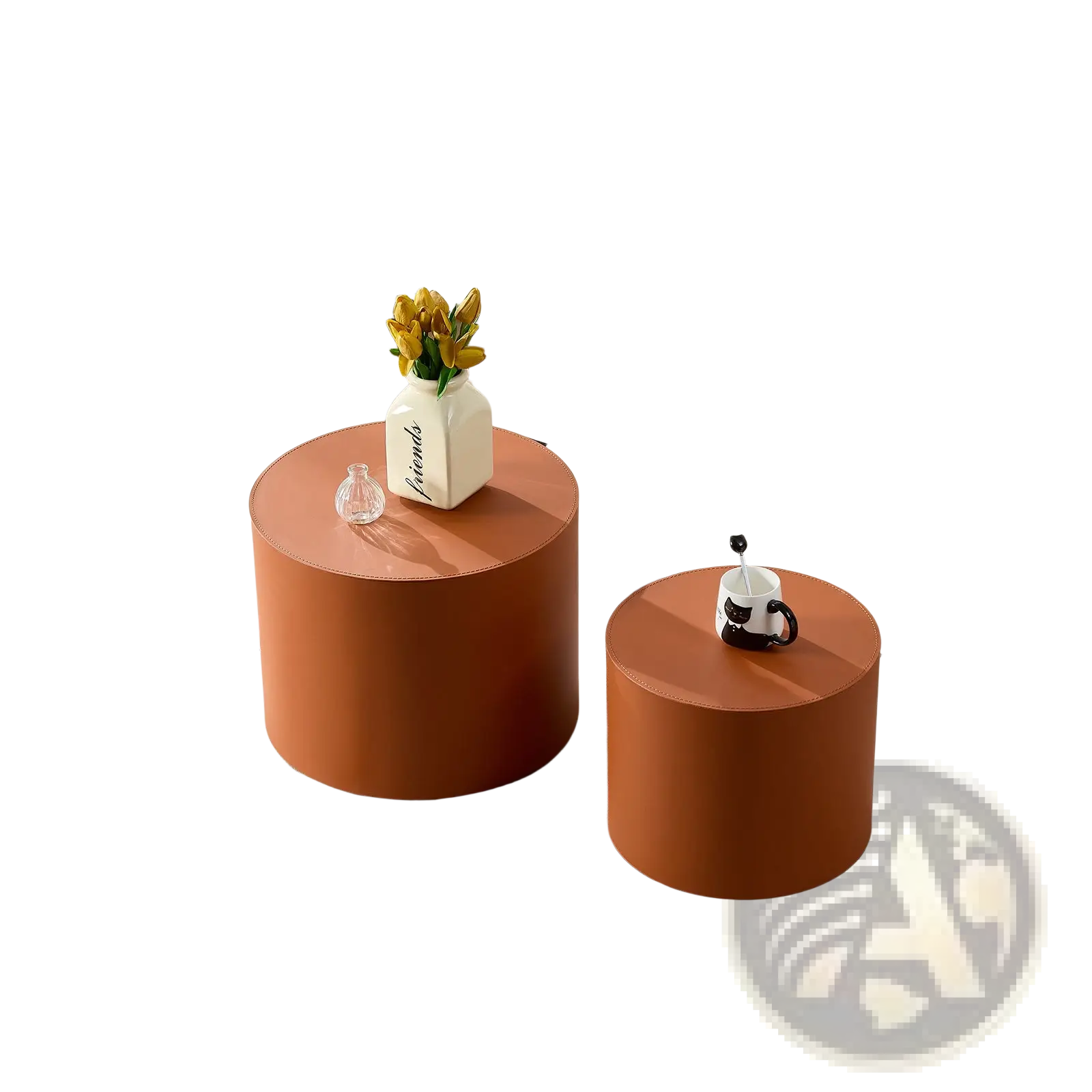 Two cylindrical orange saddle leather round coffee tables with smooth matte finish in a matching set