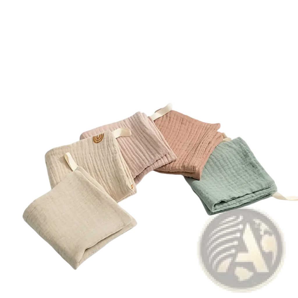 Organic cotton baby bath towel and muslin set with soft pastel muslin cloths featuring ribbed texture and woven tags