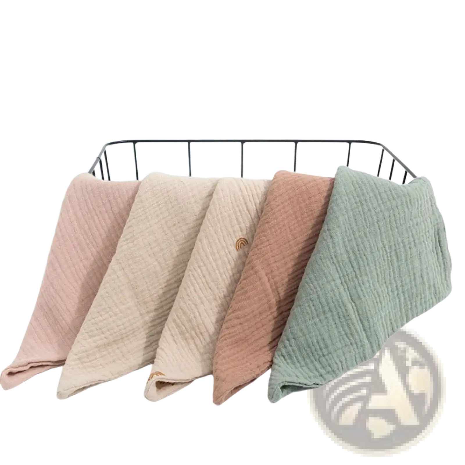 Soft textured organic cotton muslin baby bath towels in pastel pink beige terracotta and sage green neatly folded