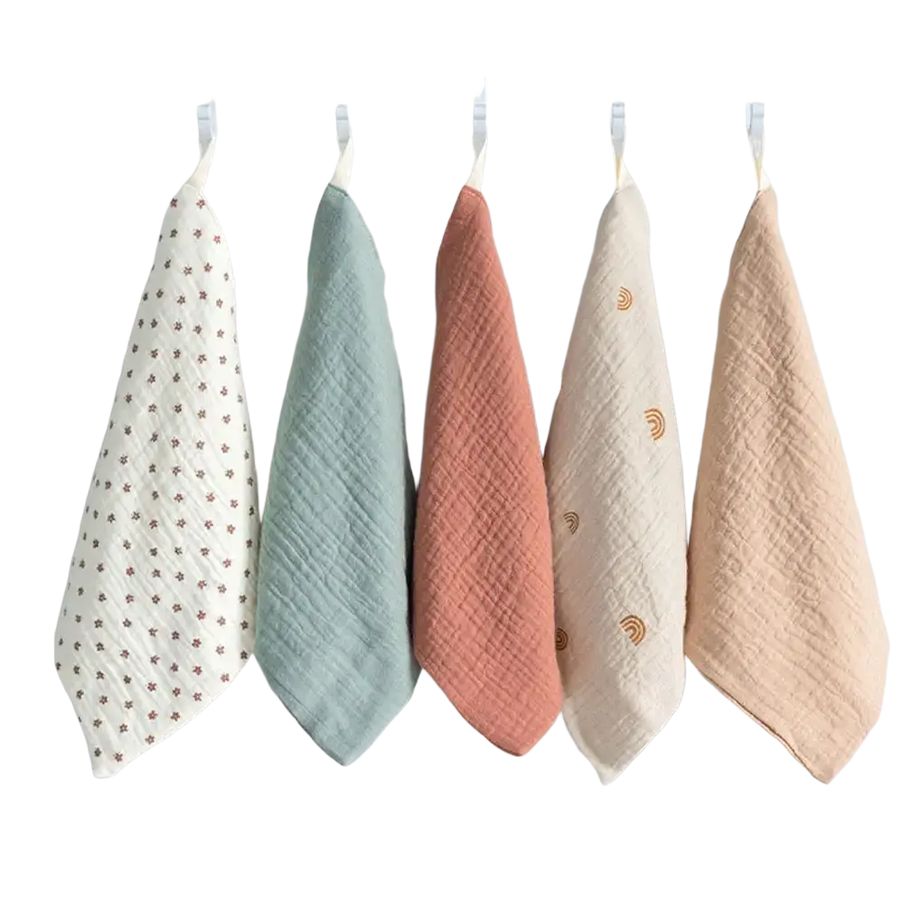 Organic cotton baby bath towel and muslin set with five pastel textured muslin cloths on a white rack