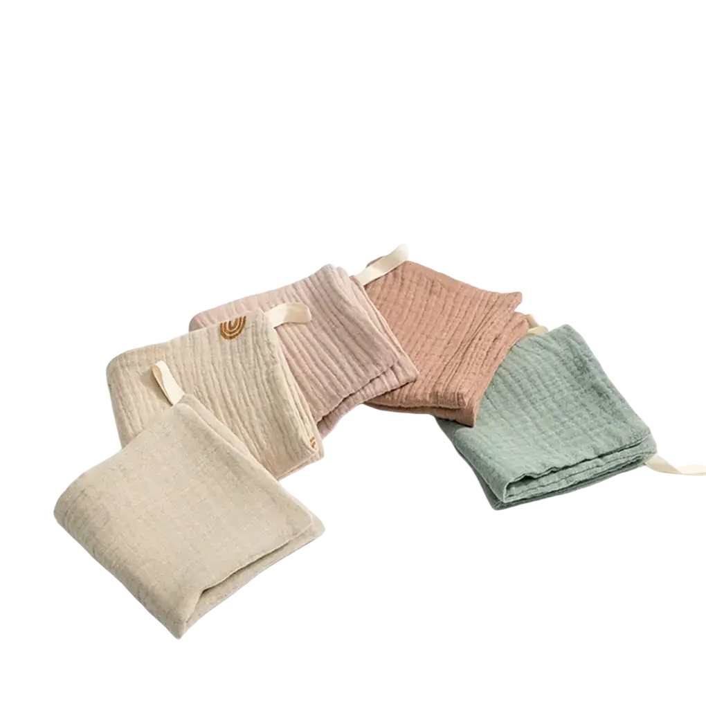 Organic cotton baby bath towel and muslin set with soft pastel muslin cloths featuring ribbed texture and woven tags
