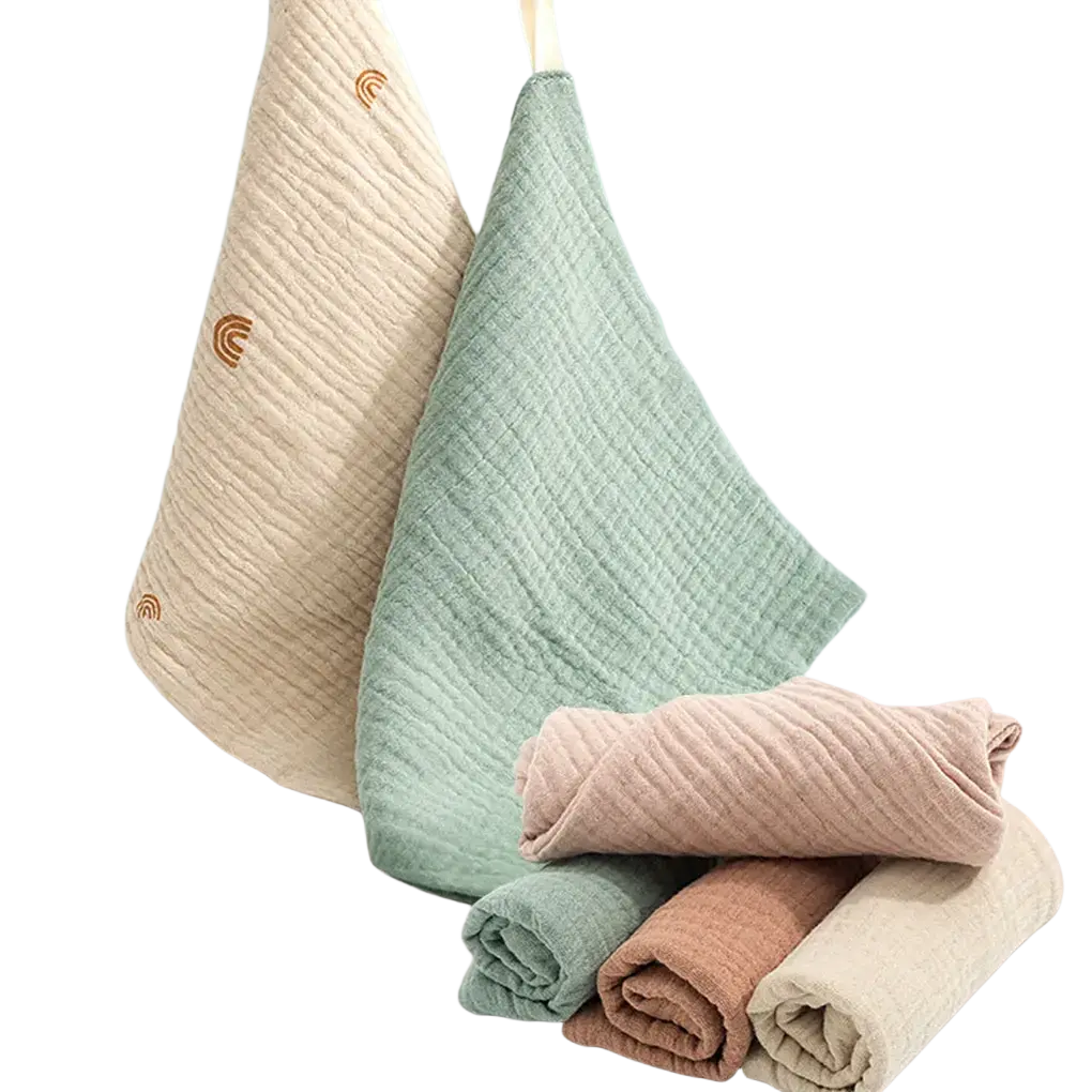 Organic cotton baby bath towel and muslin set with soft pastel colors ribbed texture and small rainbow embroidery