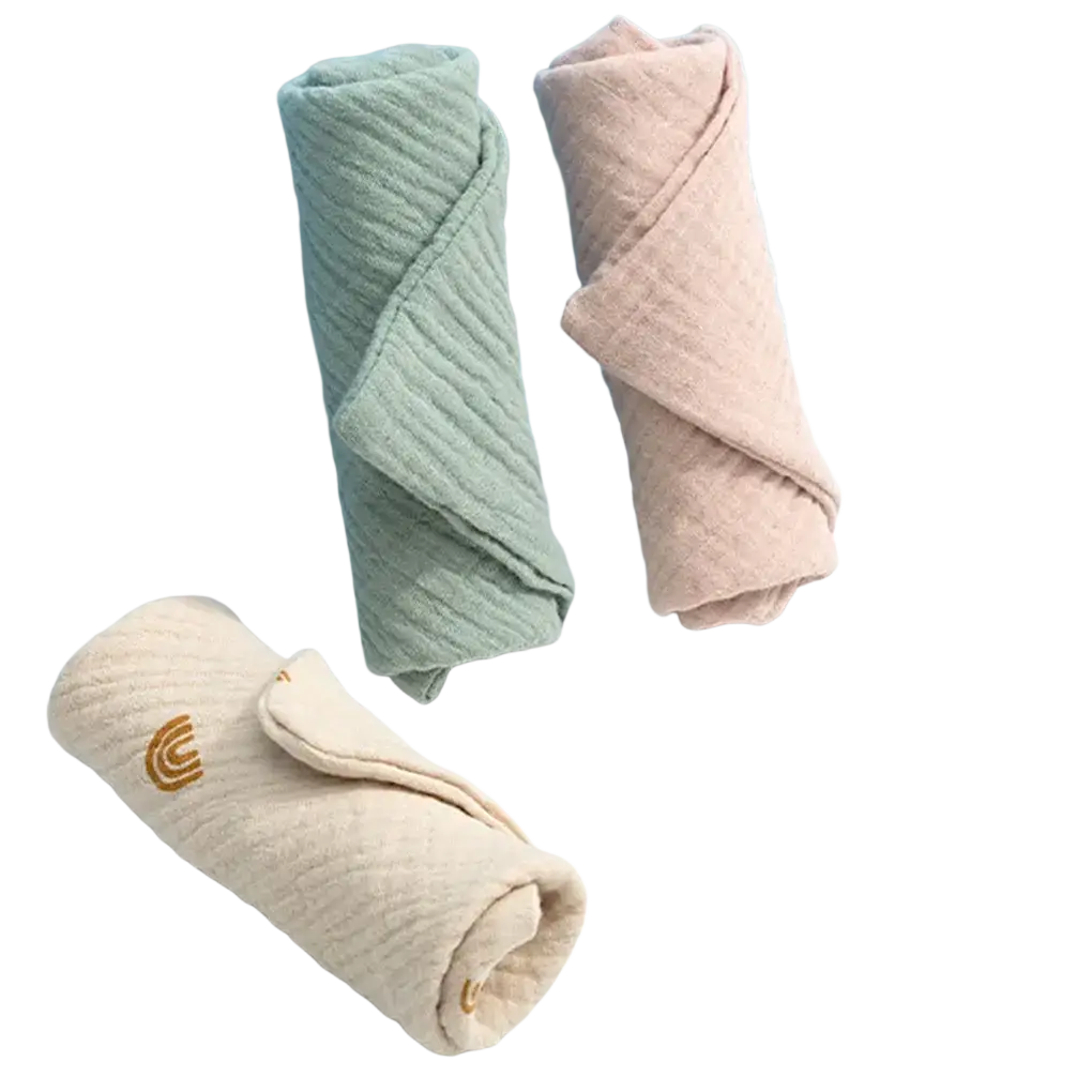 Organic cotton baby bath towel and muslin set with soft rolled wraps in sage green, blush pink, and beige with gold logo