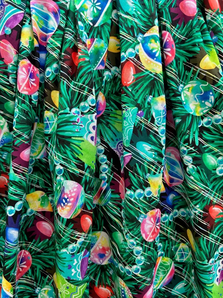 Ornaments Doris retro holiday pleated skirt with pockets featuring vibrant Christmas-themed fabric with colorful ornaments and pine branches