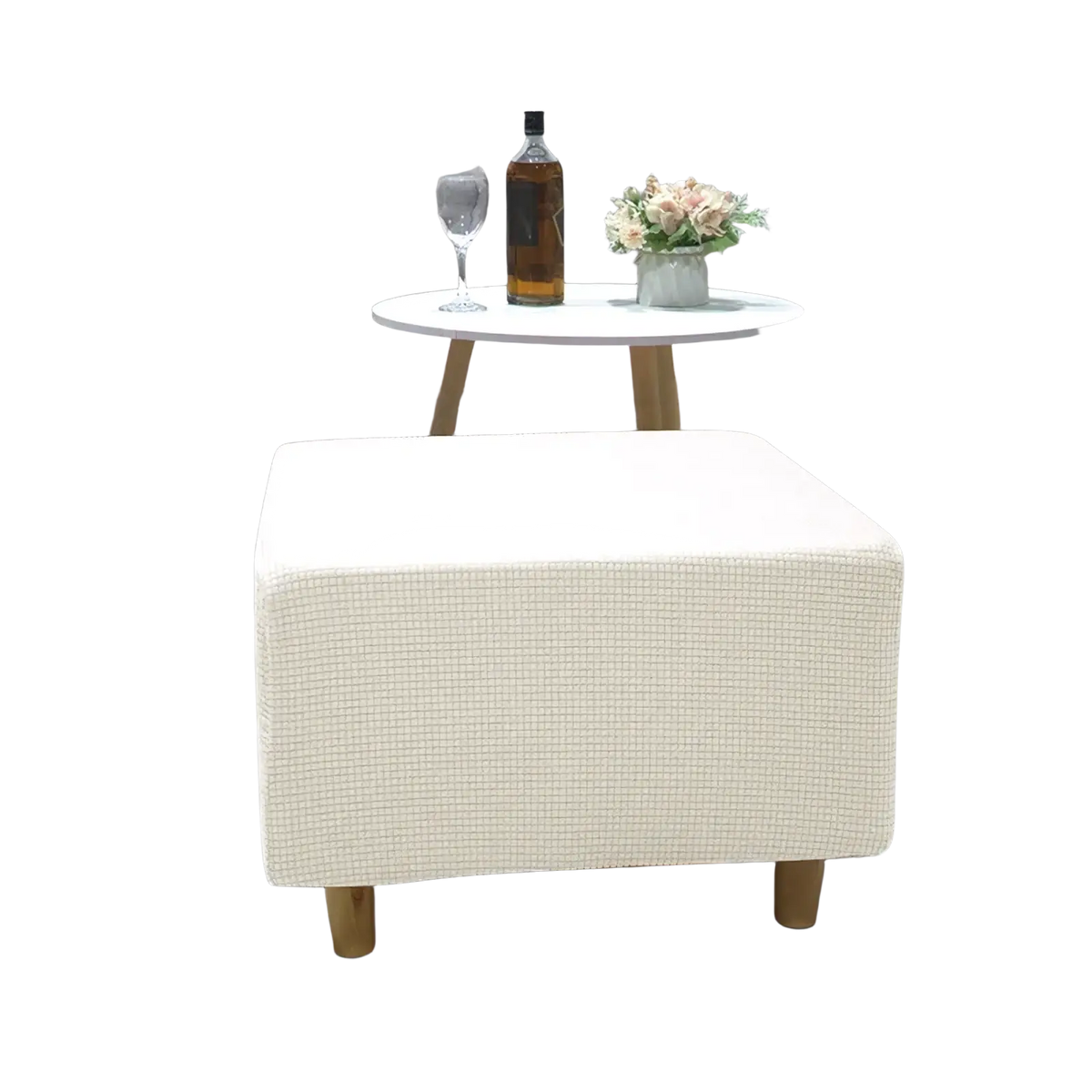 Cream-colored textured fabric ottoman with wooden legs featuring a stretch elastic slipcover for footrest protection