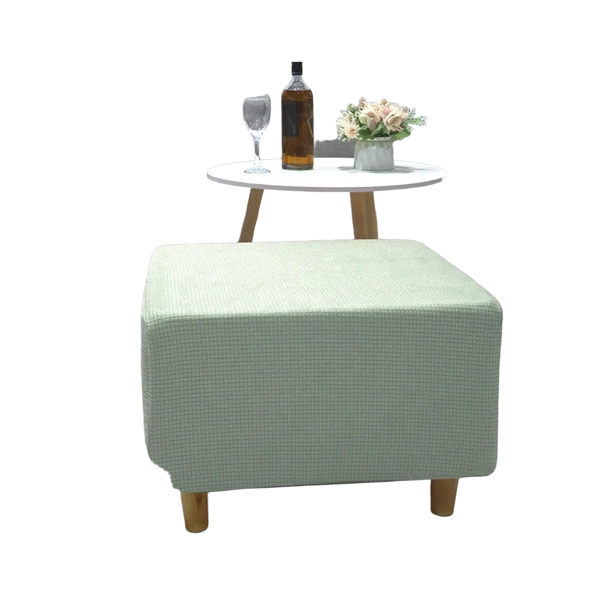 Light green textured fabric ottoman with wooden legs featuring a stretch elastic slipcover for footrest protection