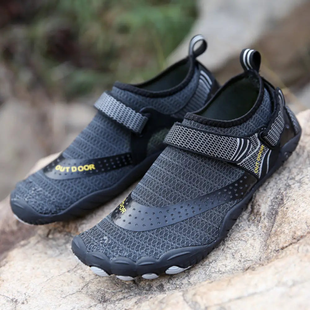 Lightweight cut resistant five finger outdoor wading shoes in black and gray mesh with yellow outdoor branding