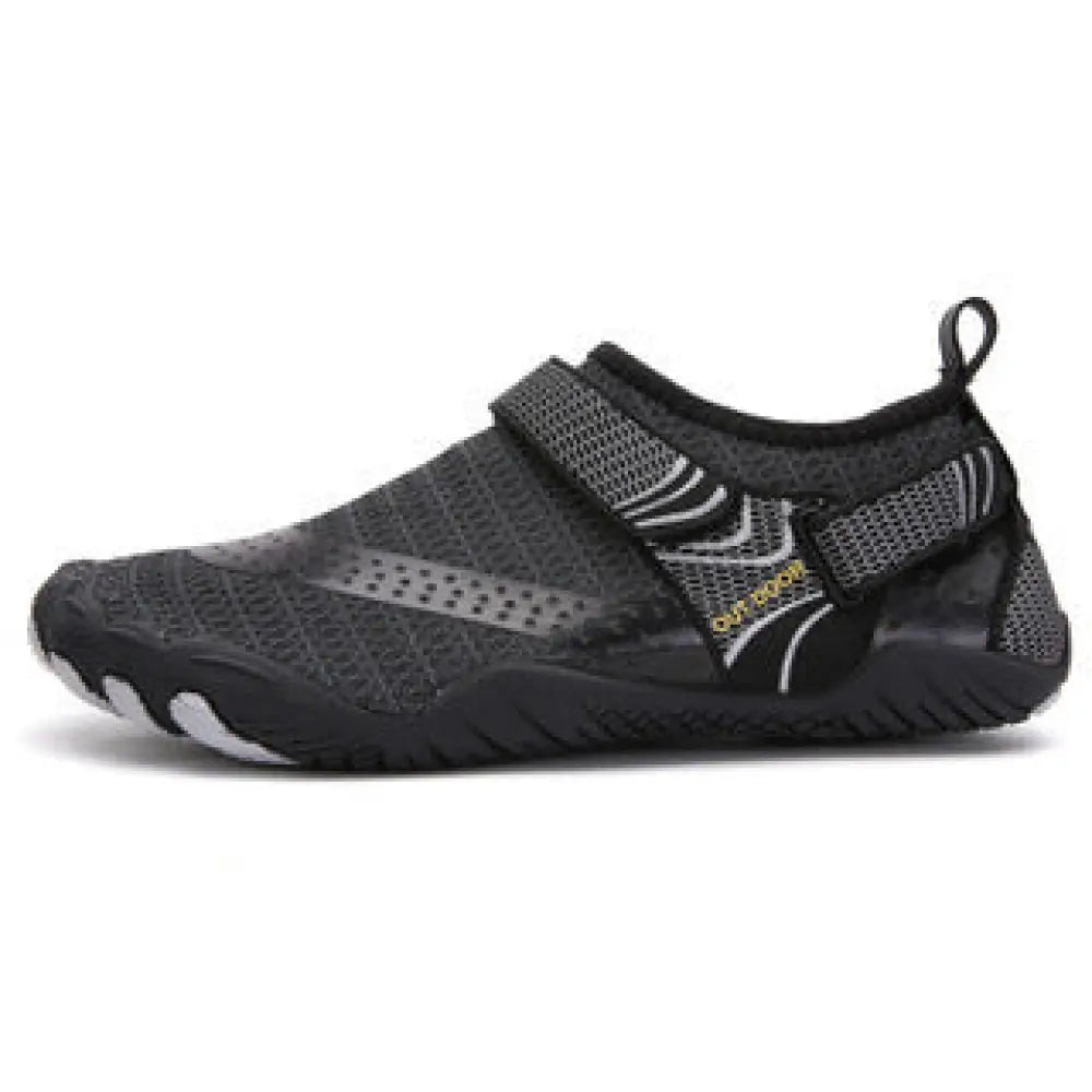 Lightweight cut resistant five finger outdoor wading shoe in black and gray mesh with strap closure and white sole accents