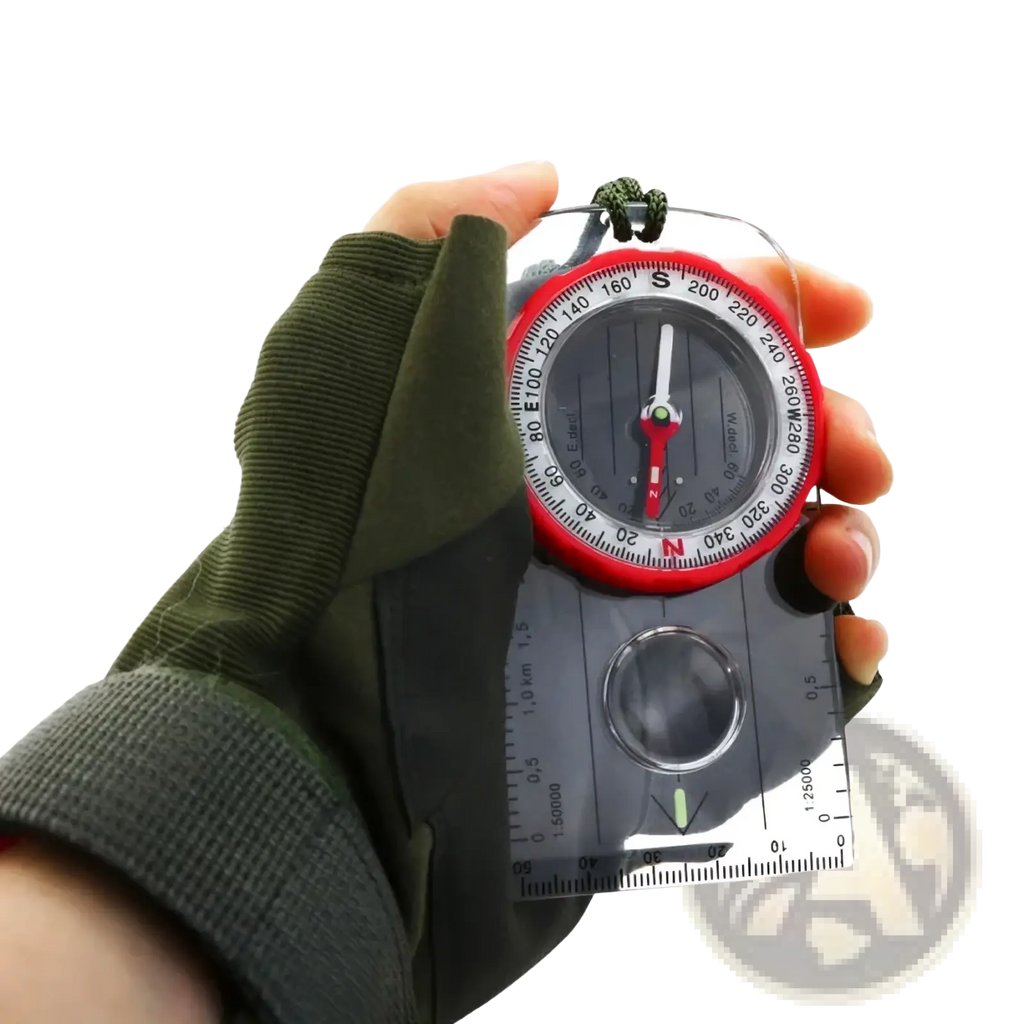 Outdoor navigation compass with red and black design, transparent ruler, and lanyard held in a green glove