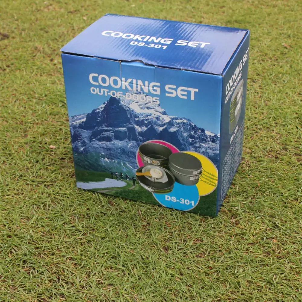 Blue cardboard box of Arbaglobal 10 piece non stick camping cookware set with outdoor cooking label and mountain design