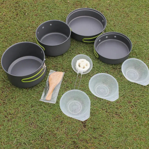 Set of four black aluminum non stick camping pots with lime green handles and wooden spoon in arbaglobal cookware set packaging