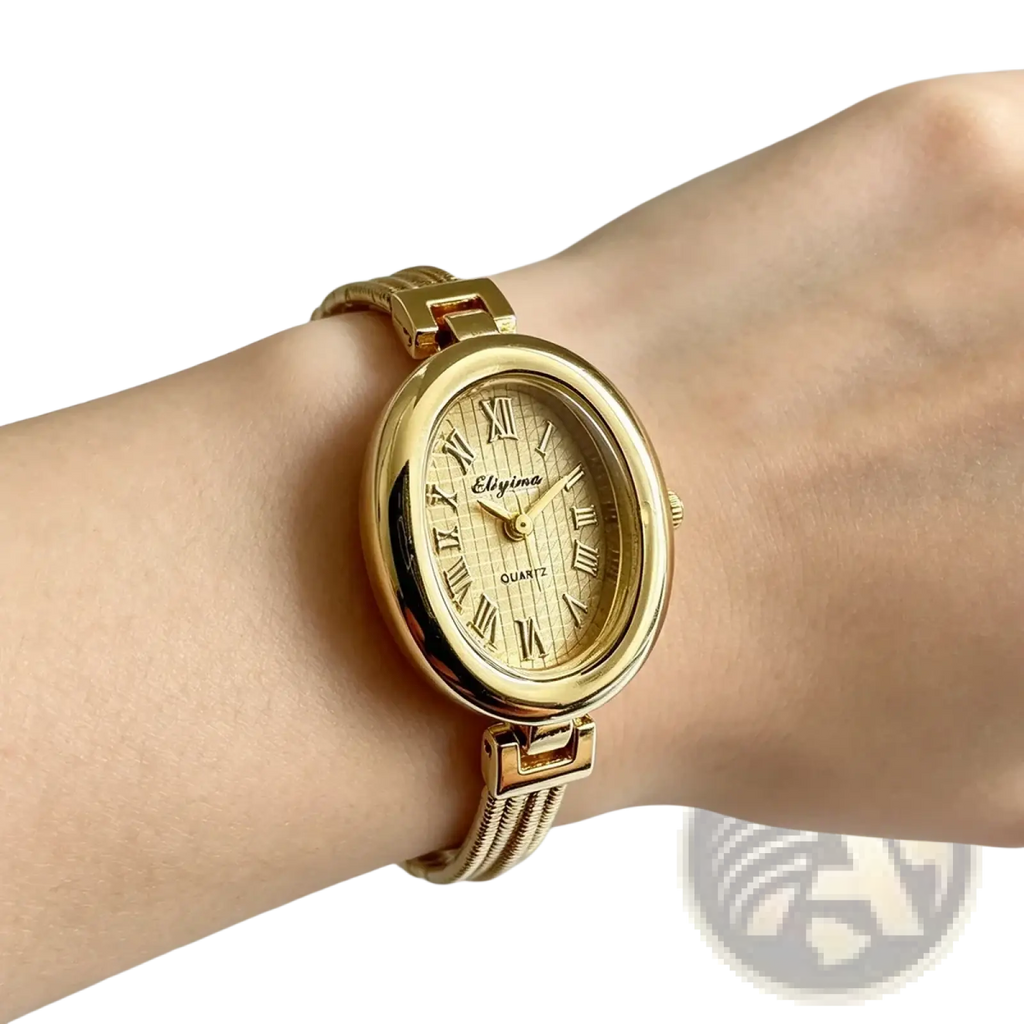 Gold-toned oval-faced quartz women watch with roman numerals and textured dial worn on wrist