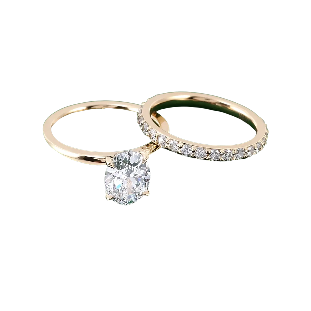 A pair of elegant gold oval lab diamond bridal set rings featuring an oval-cut center diamond and a diamond band