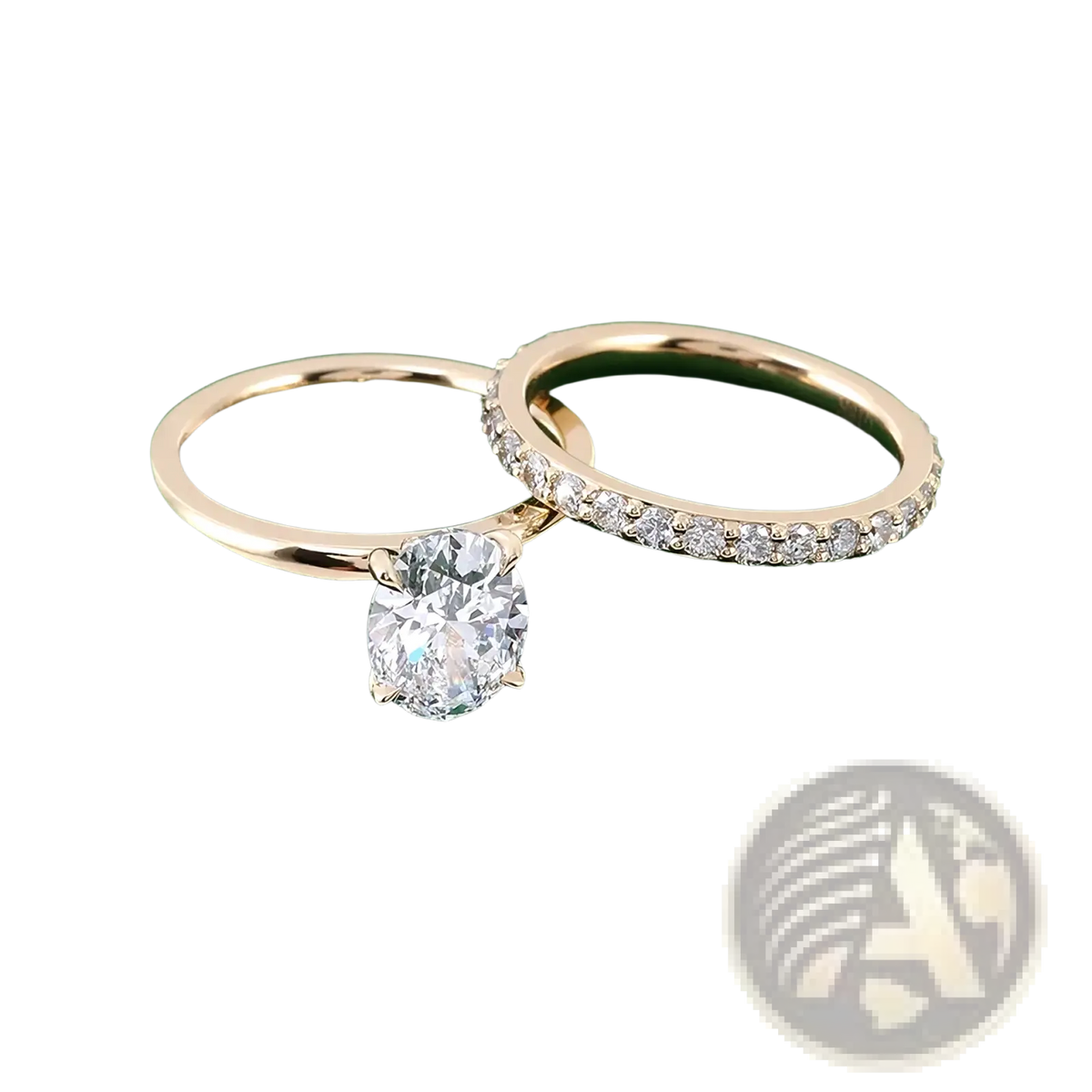 A pair of elegant gold oval lab diamond bridal set rings featuring an oval-cut center diamond and a diamond band