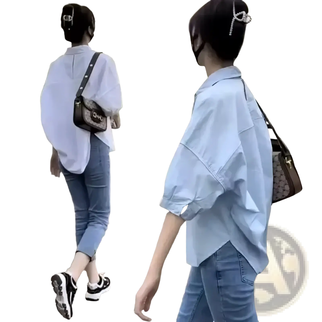 Light blue oversized button-up shirt for women with rolled sleeves and slightly asymmetrical hemline for office casual wear