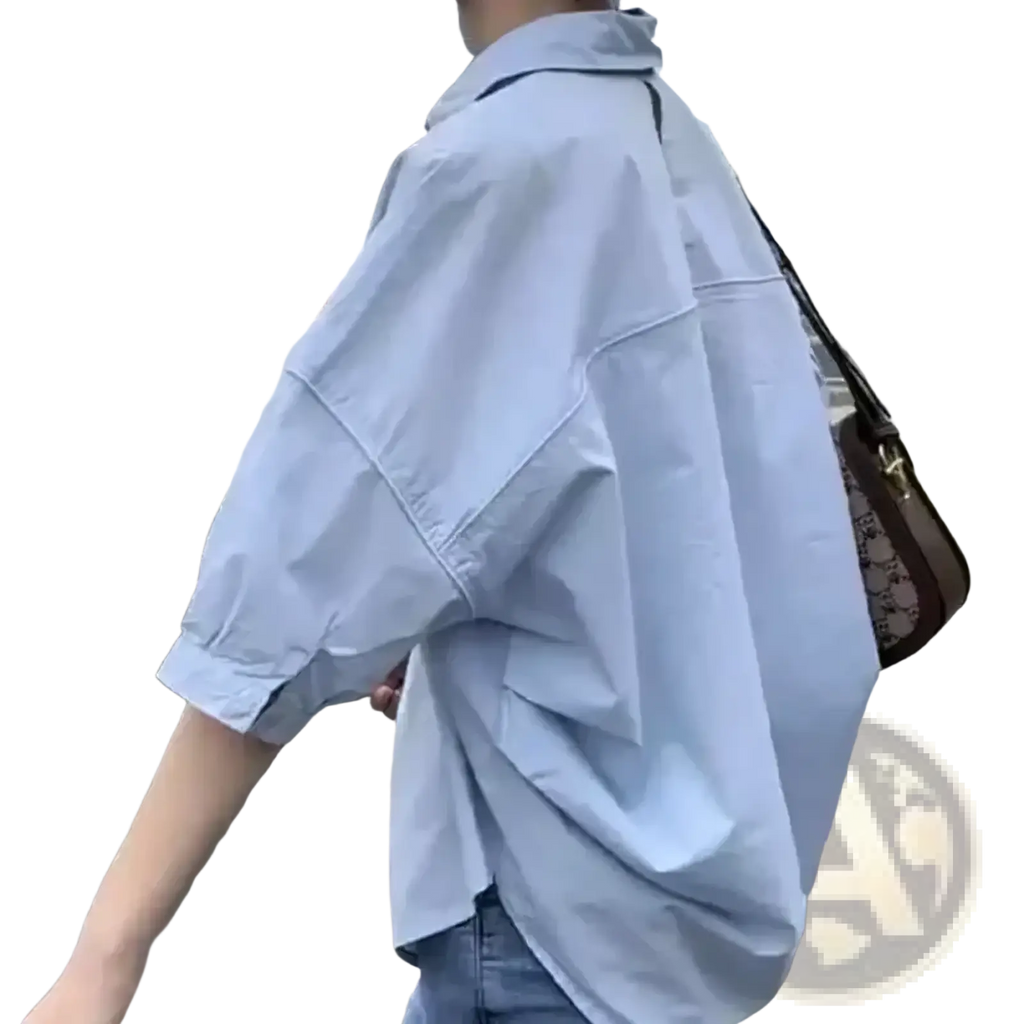 Light blue oversized cotton button up shirt for women with rolled sleeves and a relaxed fit for office casual wear