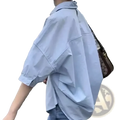 Light blue oversized cotton button up shirt for women with rolled sleeves and a relaxed fit for office casual wear