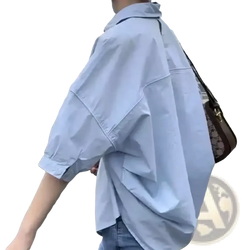 Light blue oversized cotton button up shirt for women with rolled sleeves and a relaxed fit for office casual wear
