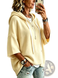 Cream-colored oversized fleece hooded top with three-quarter sleeves and white drawstrings in a relaxed fit
