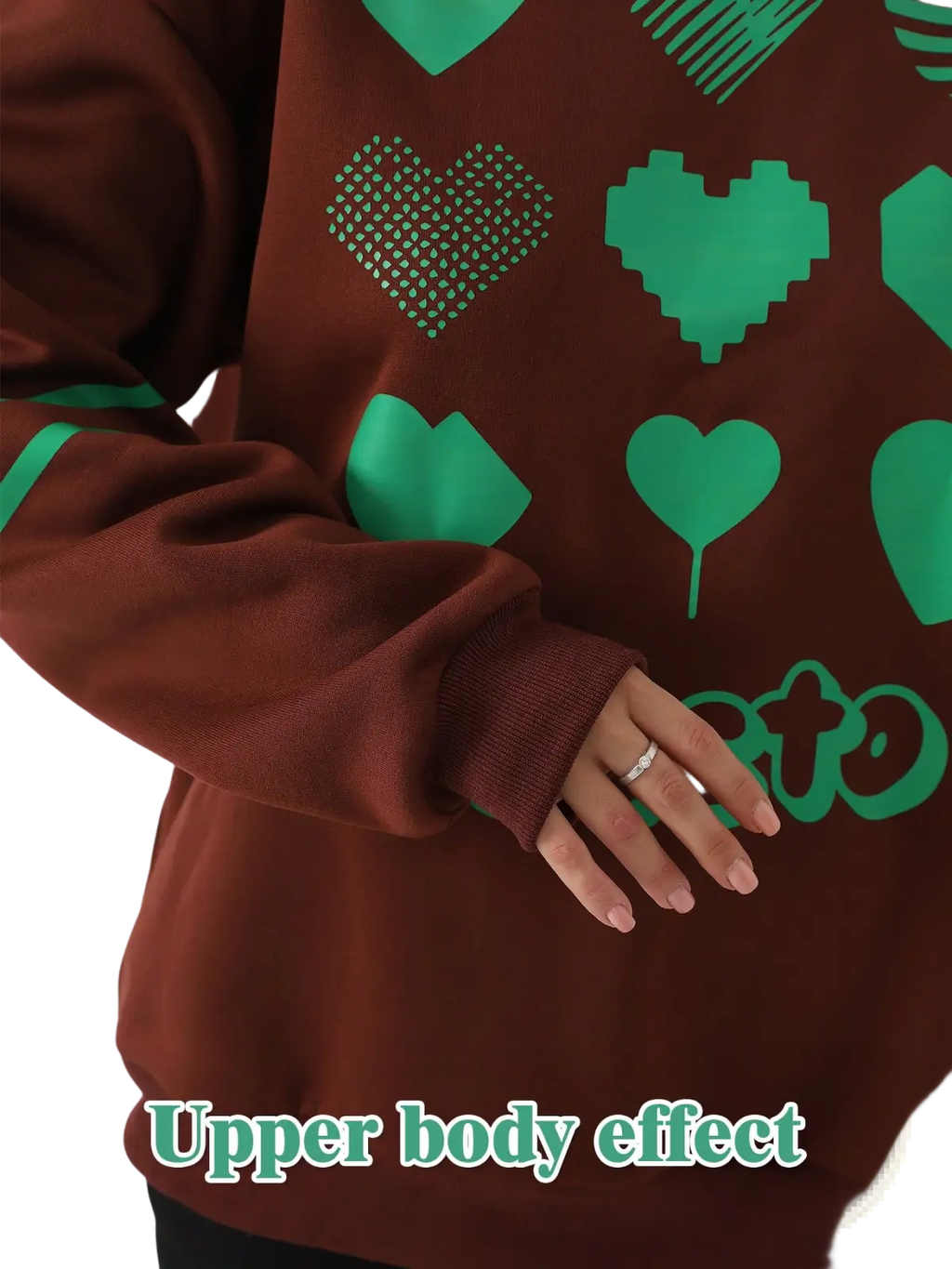 A brown oversized heart pattern graphic sweatshirt with playful green pixelated and solid hearts in various textures