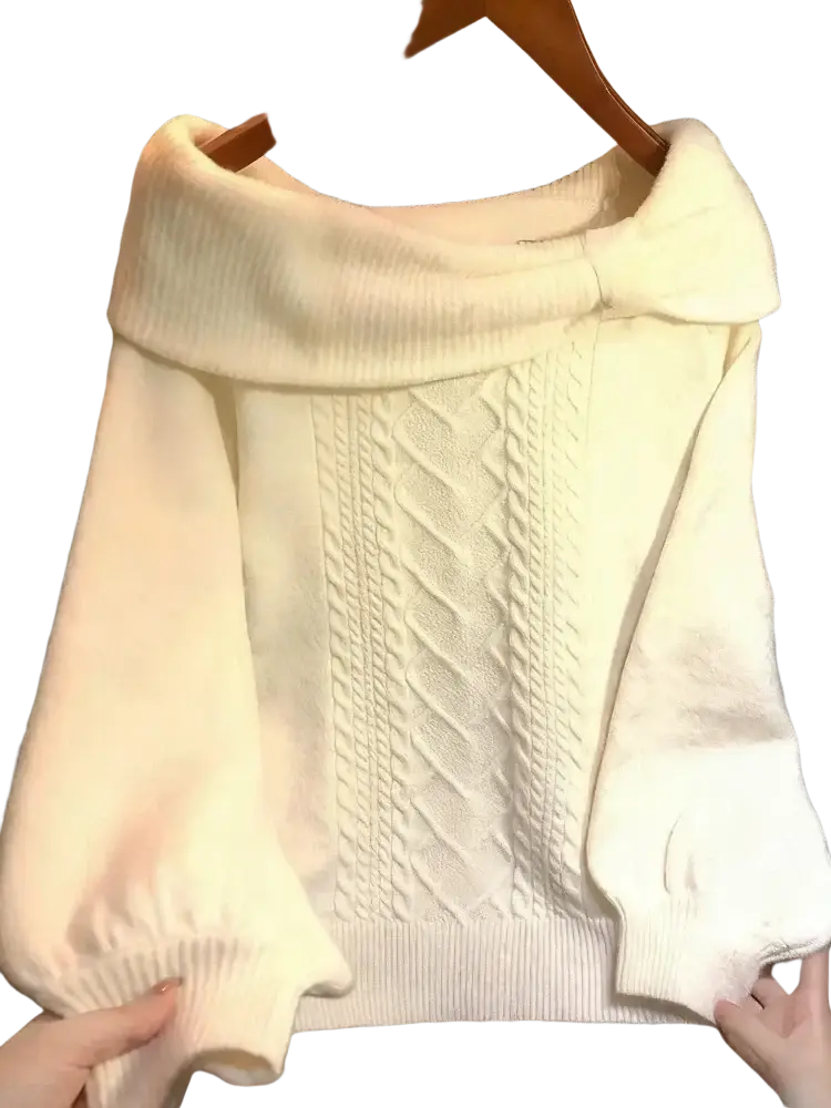 Cream-colored oversized knit sweater with wide cowl neck and intricate cable-knit pattern for winter wear