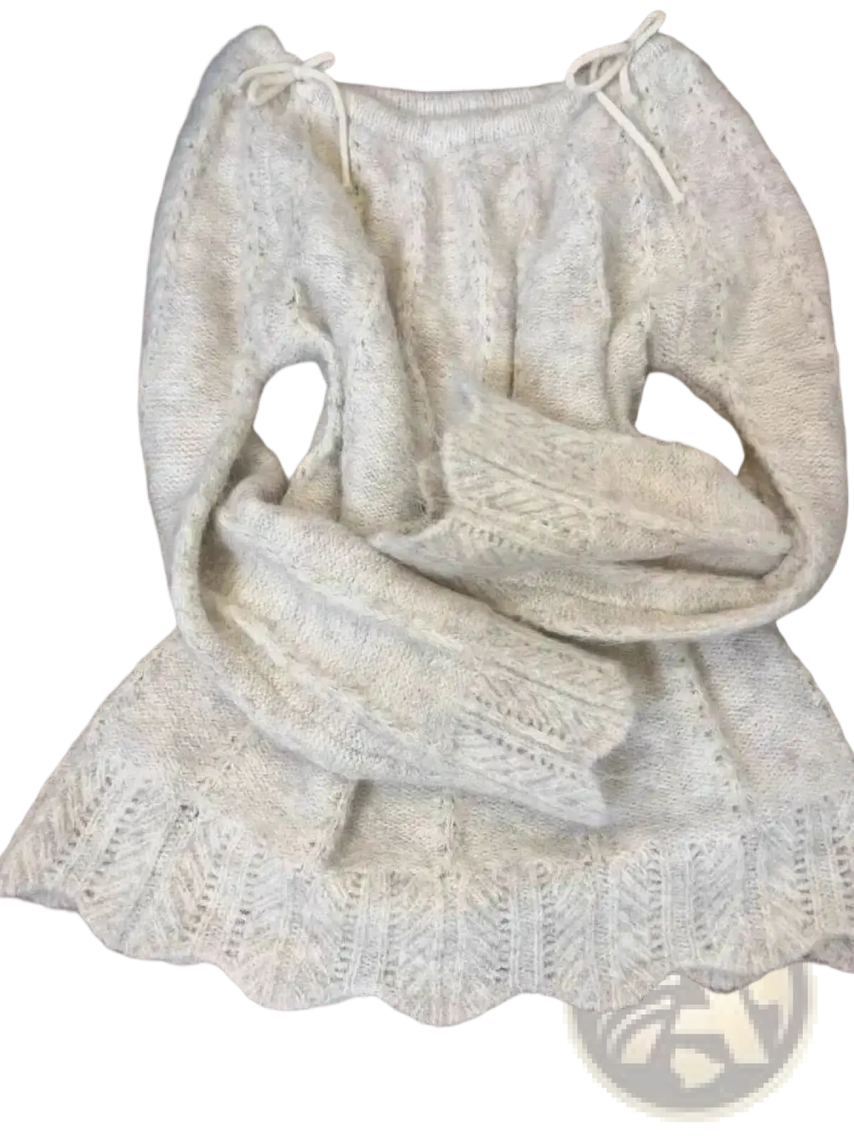 A cream-colored knitted oversized sweater with scalloped hem and drawstring ties in korean winter fashion