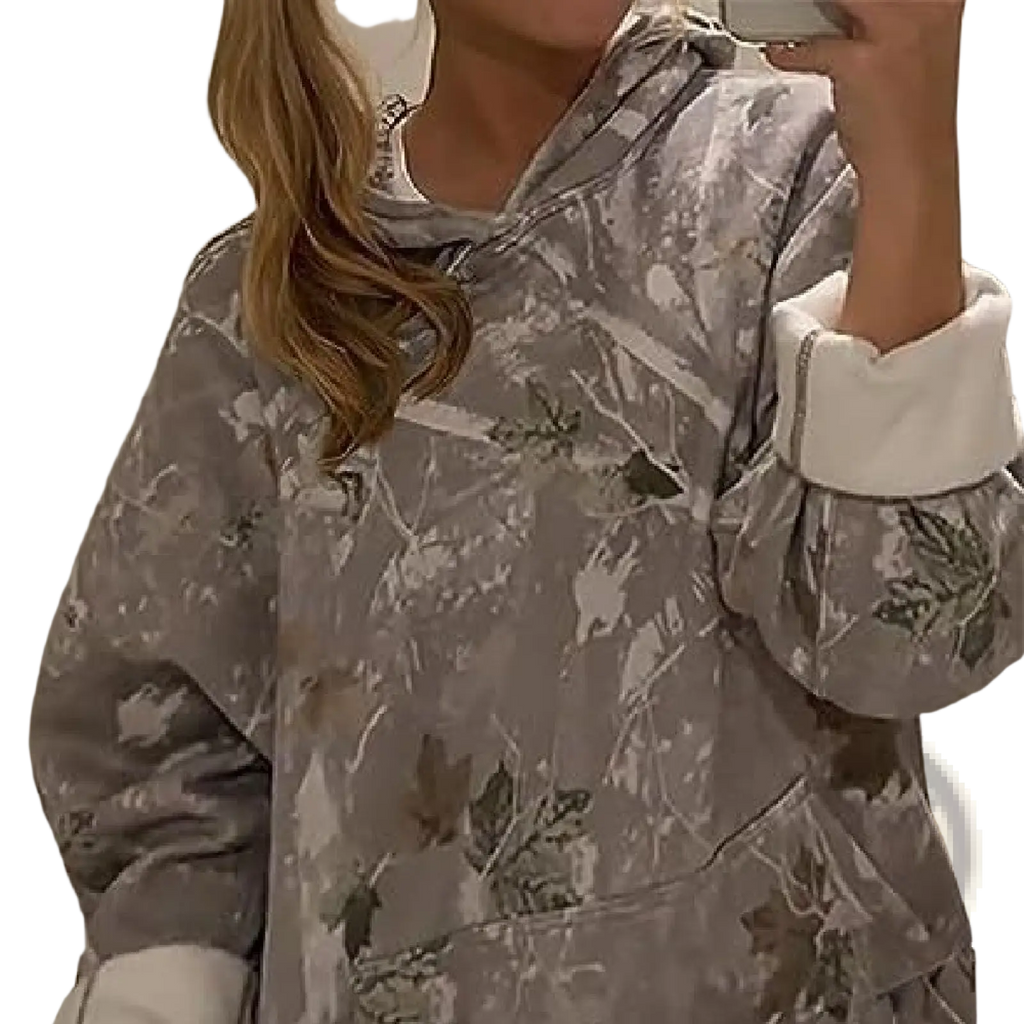 Gray oversized leafy camouflage hoodie with lantern sleeves and white ribbed cuffs in front view