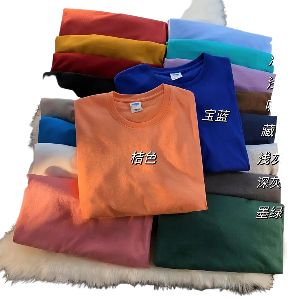 A neatly folded orange cotton oversized long sleeve blank t-shirt with a classic crew neck and short sleeves among solid colors